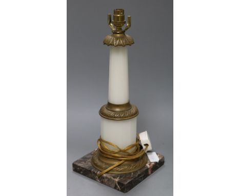 A marble and metal mounted table lamp on marble base