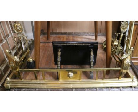 A brass fender and irons, together with a clock bracket W.119cm and 46cm