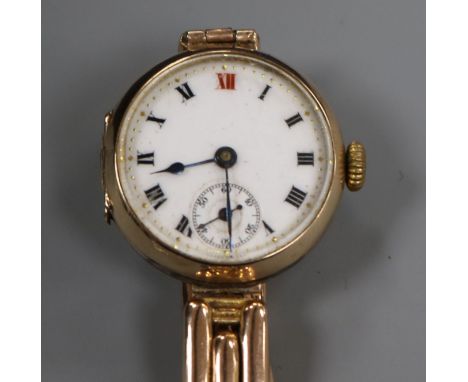 An early 20th century 9ct gold manual wind wrist watch on a 9ct gold bracelet.