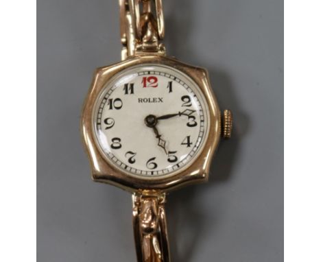 A lady's early 20th century 9ct gold manual wind wrist watch, with Rolex dial and case, movement unsigned, on 9ct gold bracel