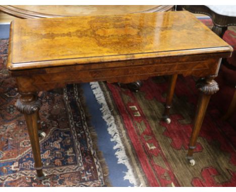 A Victorian figured walnut card table with folding top W.92cm