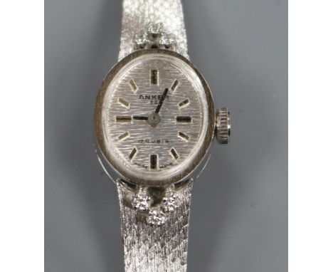 A lady's 14ct white gold and diamond set Anker manual wind wrist watch, on integral 14ct white gold bracelet.