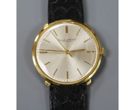 A gentleman's 18ct gold International Watch Co. manual wind wrist watch, on associated leather strap.