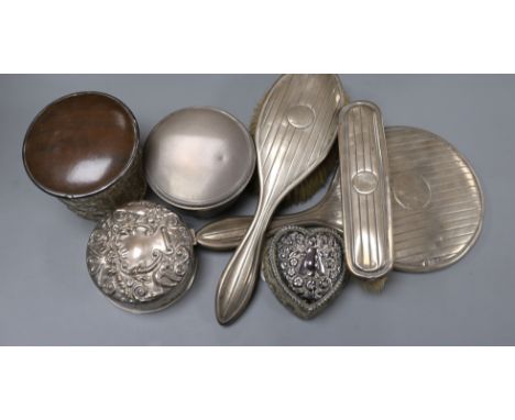 An engine-turned silver three-piece dressing table set, three trinket boxes and a toilet jar, the trinket boxes comprising a 