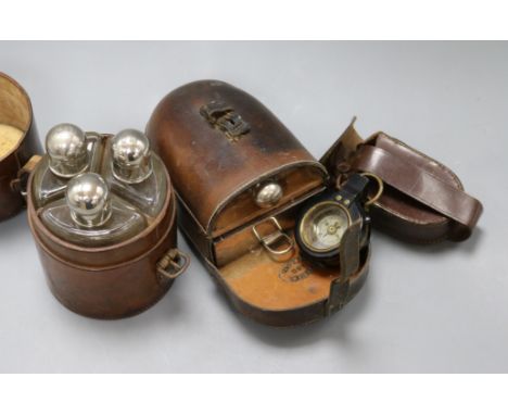 A leather cased flask and box, similar triple spirit flasks and an early 20th century compass