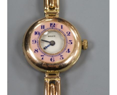 A lady's early 20th century 9ct gold and enamel Rolex manual wind wrist watch, on a 9ct gold bracelet.