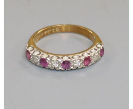 An 18ct gold, ruby and diamond half-hoop ring, size M.