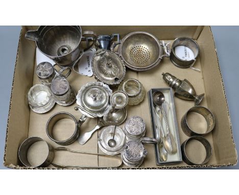 A group of silver and silver-mounted condiments, napkin rings, spoons and sundries, comprising a pair of silver-mounted glass