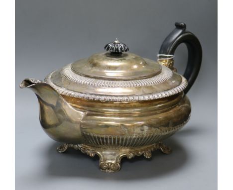 A George IV silver melon-shaped teapot, half-fluted and having ebonised handle and finial, gadrooned rim, leaf-decorated spou