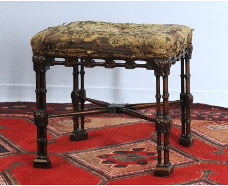 A carved mahogany stool with turned cluster colums united by an X stretcher terminating in block feet.  A 19th/20c copy of a 