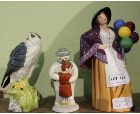 A Royal Doulton figurine of the balloon lady, together with the snowman and Doulton White and McKay Scotch whisky model Merli