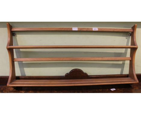 A light coloured elm Ercol branded wall hanging plate rack 