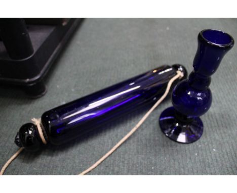 A Bristol blue glass rolling pin, together with a Thomas Webb blue glass candlestick (2) 