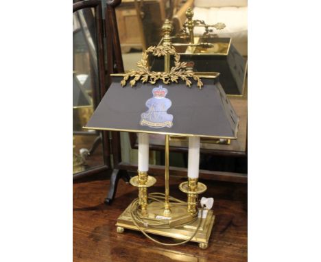 A brass finished twin sconce desk lamp, with crested shade 
