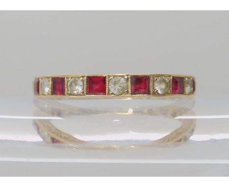 A 9ct gold full eternity ring set with red and clear gems (one clear one missing) size R, weight 2.2gms Condition Report: Ava