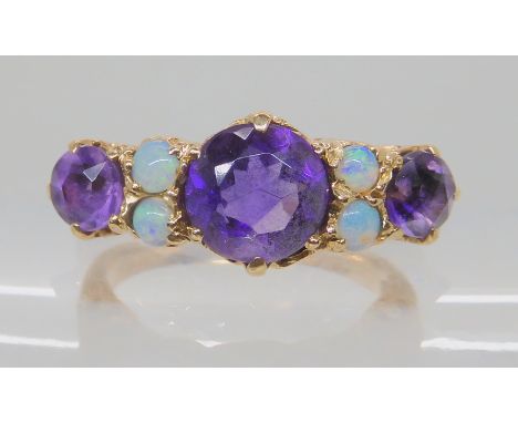 A 9ct gold amethyst and opal cluster ring, size N, weight 3.7gms Condition Report: 9ct' hallmark almost obliterated. None of 
