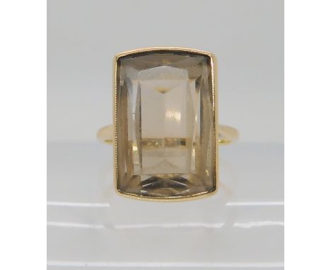 A 9ct gold smoky quartz set ring, size N1/2, weight 5.8gms Condition Report: Very light abraisions to the top facets, light w
