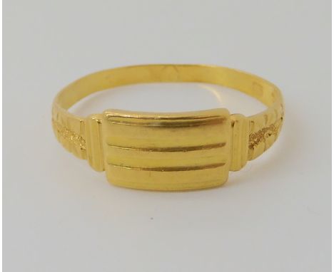 A bright yellow metal ring stamped 916 (22ct) finger size T1/2, weight 2.4gms Condition Report: Back of the shank, has some d
