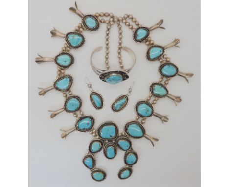 A white metal and turquoise 'Squash blossom' necklace, with matching earrings, and bangle. Condition Report: Not available fo