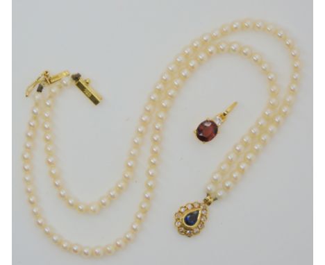 An 18ct gold sapphire and diamond pendant on a string of pearls with an 18ct gold clasp and a further bright yellow metal rub