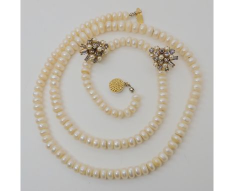 A long string of button shaped cultured pearls length 77cm, and a pair of Ciro faux pearl and diamante screw back earrings Co
