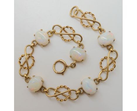 A 9ct gold Deakin & Francis white opal set knot detail bracelet, length 19cm, weight 9.8gms Condition Report: Gold work all o
