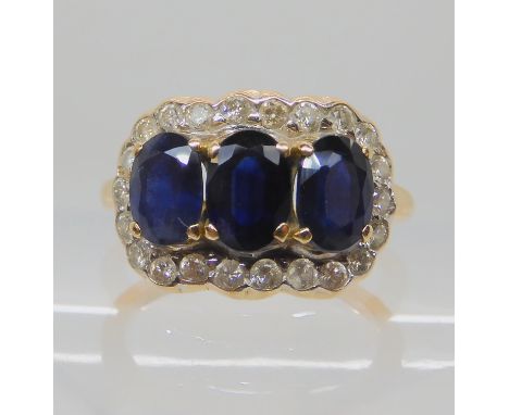 An 18ct gold three sapphire and diamond dress ring, size J, weight 4.6gms Condition Report: Stamped 750, sapphires have zonin