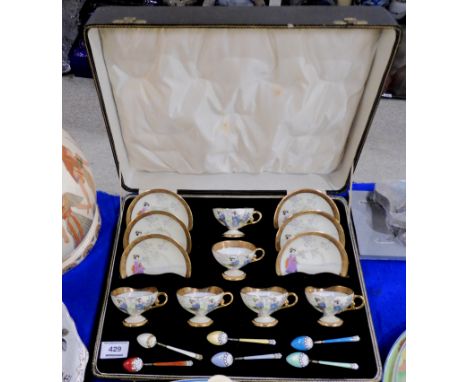 A boxed set of Noritake cups and saucers decorated with Geishas, with silver and enamel spoons Condition Report: Cups and sau