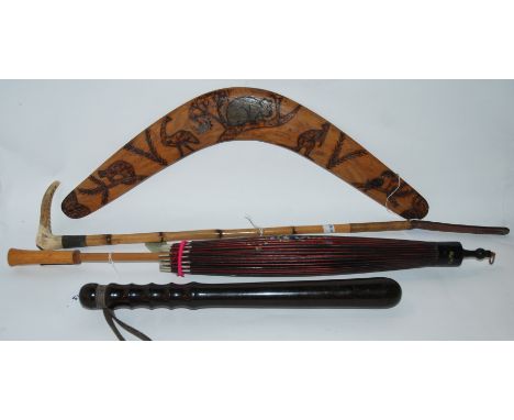 A hardwood truncheon, A Swain's bamboo riding crop, two parasols and boomerang (5) Provenance: The Late Dr Helen. E. C. Cargi