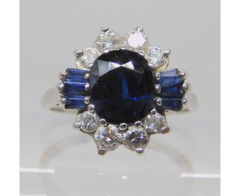 A platinum sapphire and diamond ring, the central sapphire measures 7mm x 6mm x 3.8mm, surrounded with estimated approx 0.30c