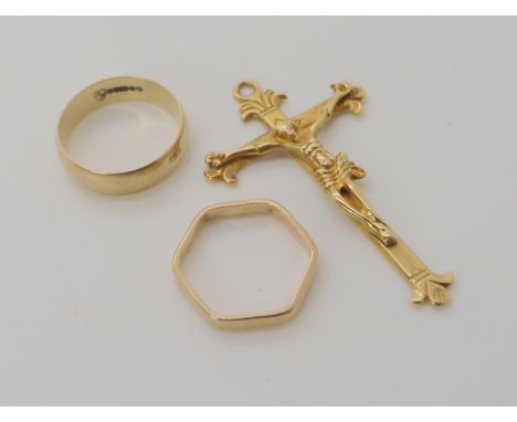 A bright yellow metal crucifix (bail missing) weight 6.6gms, together with a 9ct gold wedding ring size Q1/2, and a yellow me