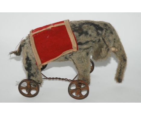A vintage possibly Steiff elephant on wheels with white felt tusks, Farnell rabbit and donkey (af) (3) Provenance: The Late D