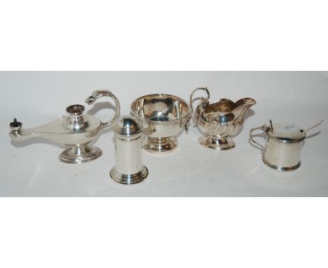 A lot comprising a small silver bowl, Birmingham 1962, a lamp table lighter, a pepperette, a mustard pot &amp; a cream jug Sh