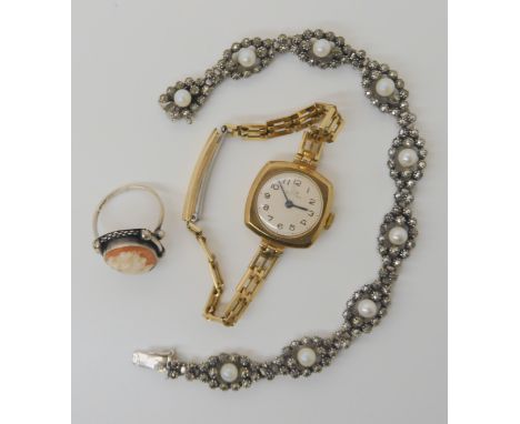 A 9ct gold cased ladies Record watch, a silver cameo ring, and a silver, marcasite and pearl bracelet Condition Report: Not a