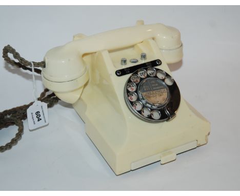 A vintage white Bakelite telephone Condition Report: Available upon request