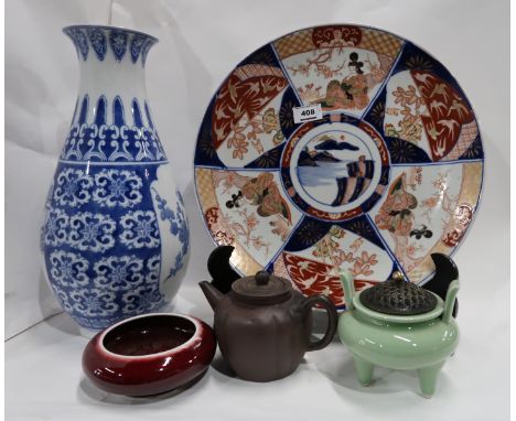 A large Imari charger, a Sang de Boeuf glazed bowl, a Celadon glazed pot with metal cover, a blue and white vase and a brown 