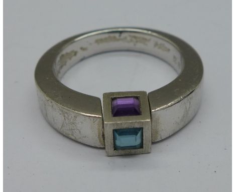 A Mont Blanc silver ring, boxed, with turning stones, two blue topaz and one amethyst, size K