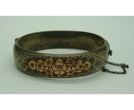 A silver and gold bangle, weight 24g