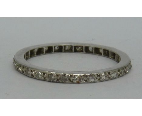 A white metal set diamond eternity ring, lacking one stone, weight 2.5g, size P