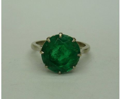 A white metal set faceted emerald ring, approximately 5ct emerald weight, 10mm in diameter, weight 4.2g, size K