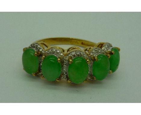 A silver gilt, jade set ring with diamond accents, size P