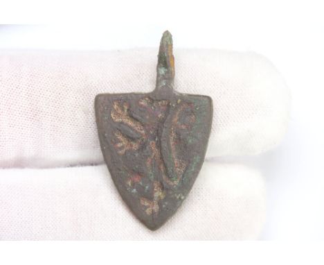 Medieval heraldic pendant. Circa 14th century CE. Copper-alloy, 10.38g. 36mm. A shield-shaped harness pendant detailed with a
