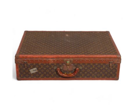 LOUIS VUITTON - hard suitcase/trunk with monogram fabric cover and straps to edges and brass mounts to corners, with cream le