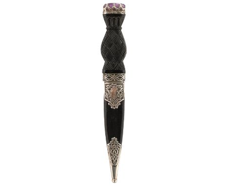 A SILVER MOUNTED SCOTTISH SGIAN DUBH, 9cm fullered blade with faceted back edge, characteristic hilt decorated with Celtic st