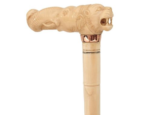 A 19TH CENTURY IVORY WALKING CANE, the double head handle carved as the head of an elephant with its trunk wrapped around a l