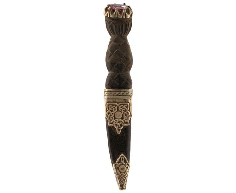 A SGEAN DUBH, basket weave carved horn grip, the pommel set with a stone, white metal mounted scabbard decorated with Celtic 