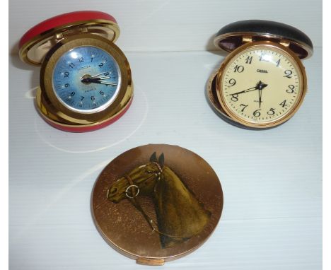 Two travel alarm clocks and a Stratton compact with horses head to lid  