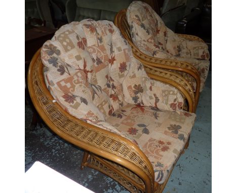 Conservatory style wicker work three piece suite comprising of two seat sofa and a pair of matching armchairs 