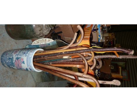 Large selection of walking sticks in ceramic umbrella stand 