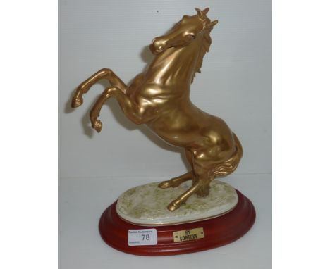 Gilt figure of a rearing horse on ceramic base 